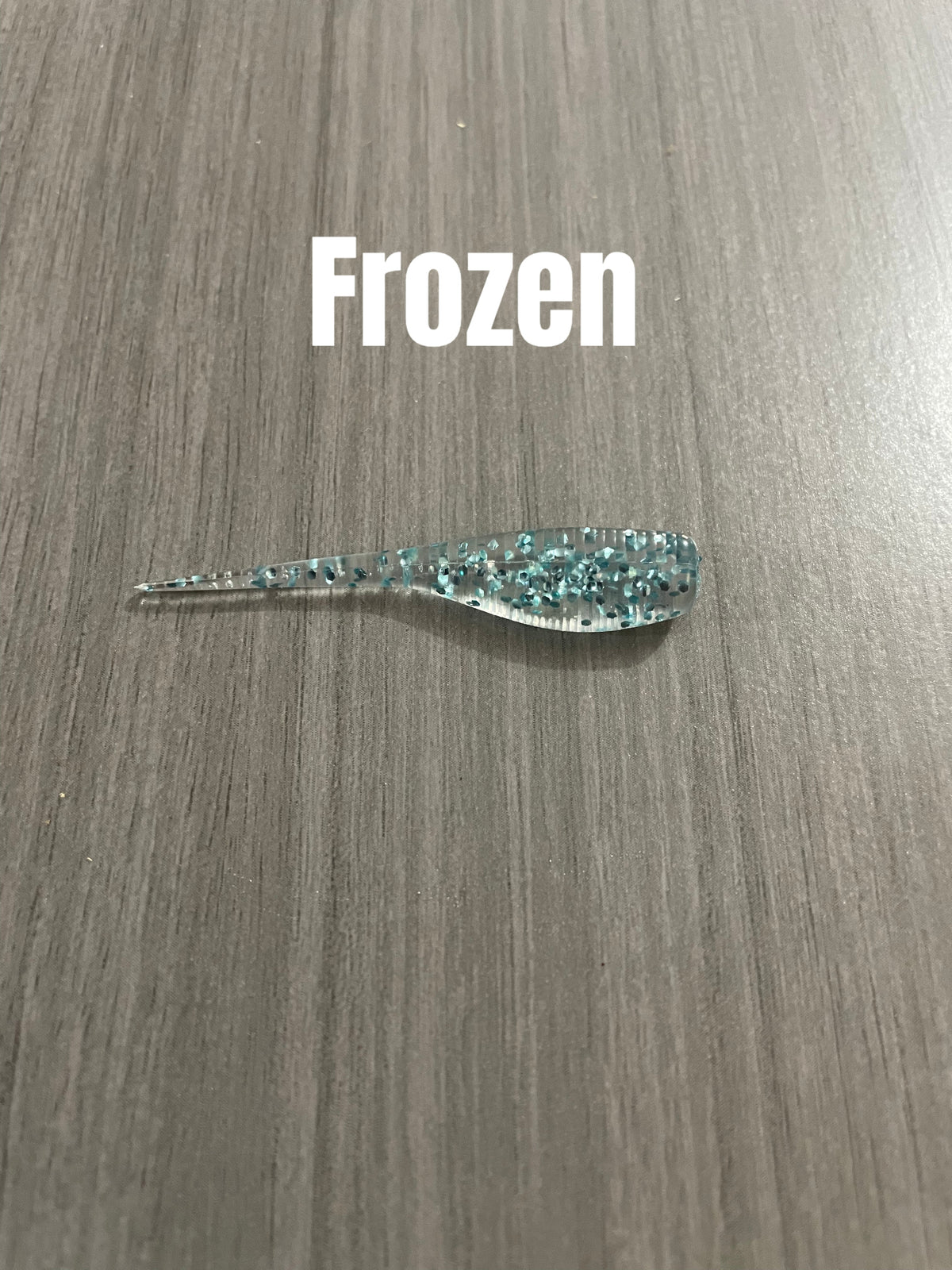 Frozen Shad Body crappie bait in clear translucent with blue-teal glitter.