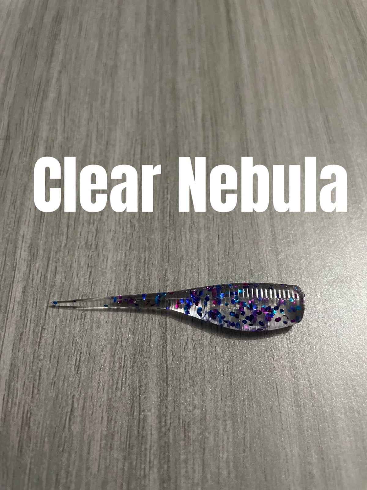 Clear Nebula Shad Body crappie bait featuring a clear ribbed body with blue and purple glitter and a clear pointed tail.