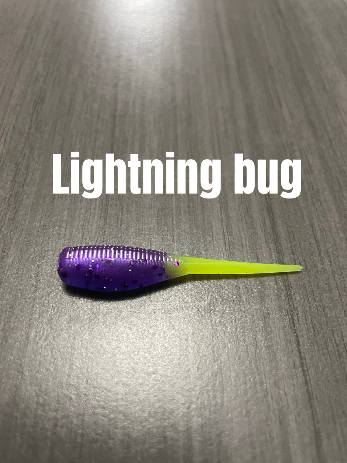 Lightning Bug Shad Body crappie bait with purple glittered ribbed body and bright chartreuse tail.