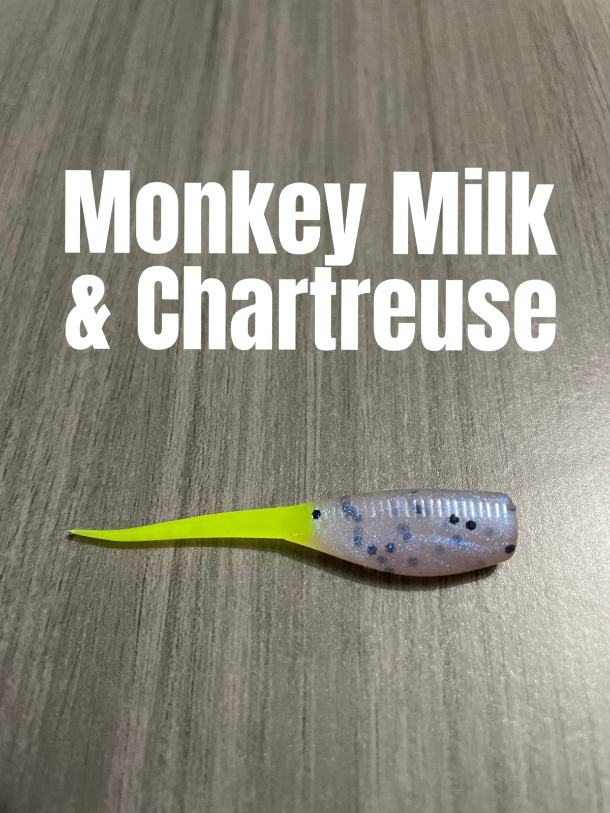 Monkey Milk and Chartreuse Shad Body crappie bait with a pearly translucent speckled body and bright chartreuse tail.