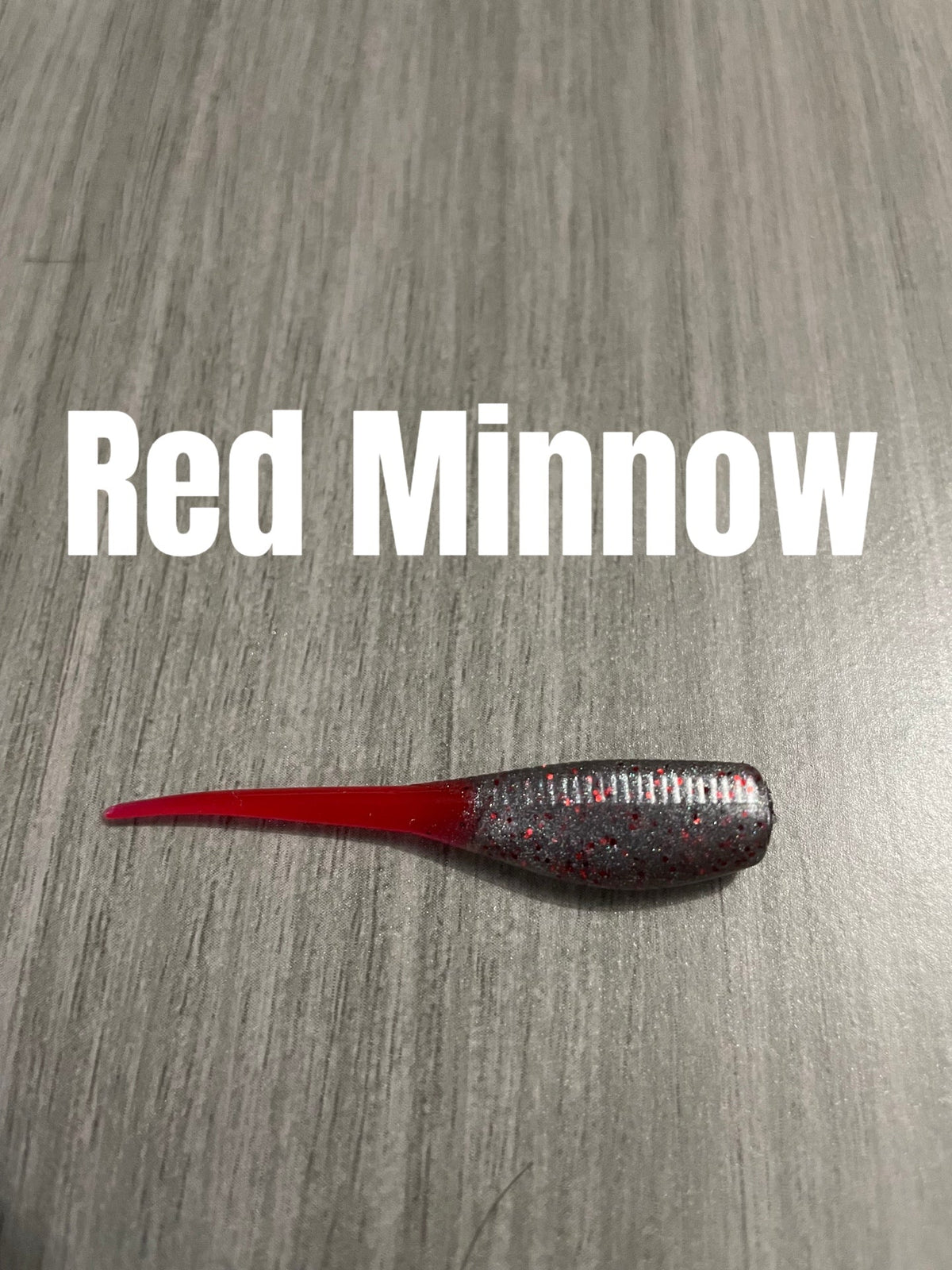 Red Minnow Shad Body crappie bait with dark red glittered ribbed body and translucent tail.