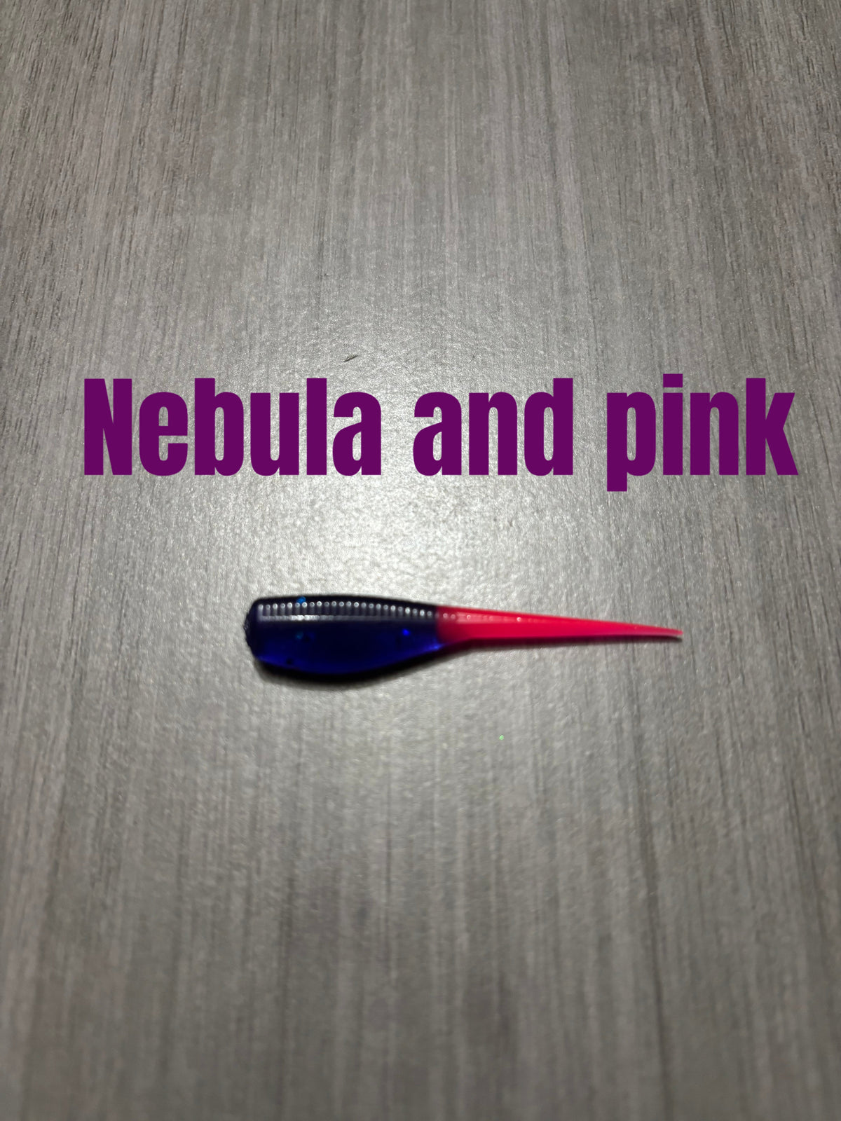 Nebula and Pink Shad Body crappie bait featuring a dark blue-purple glittered body and a bright pink tail.