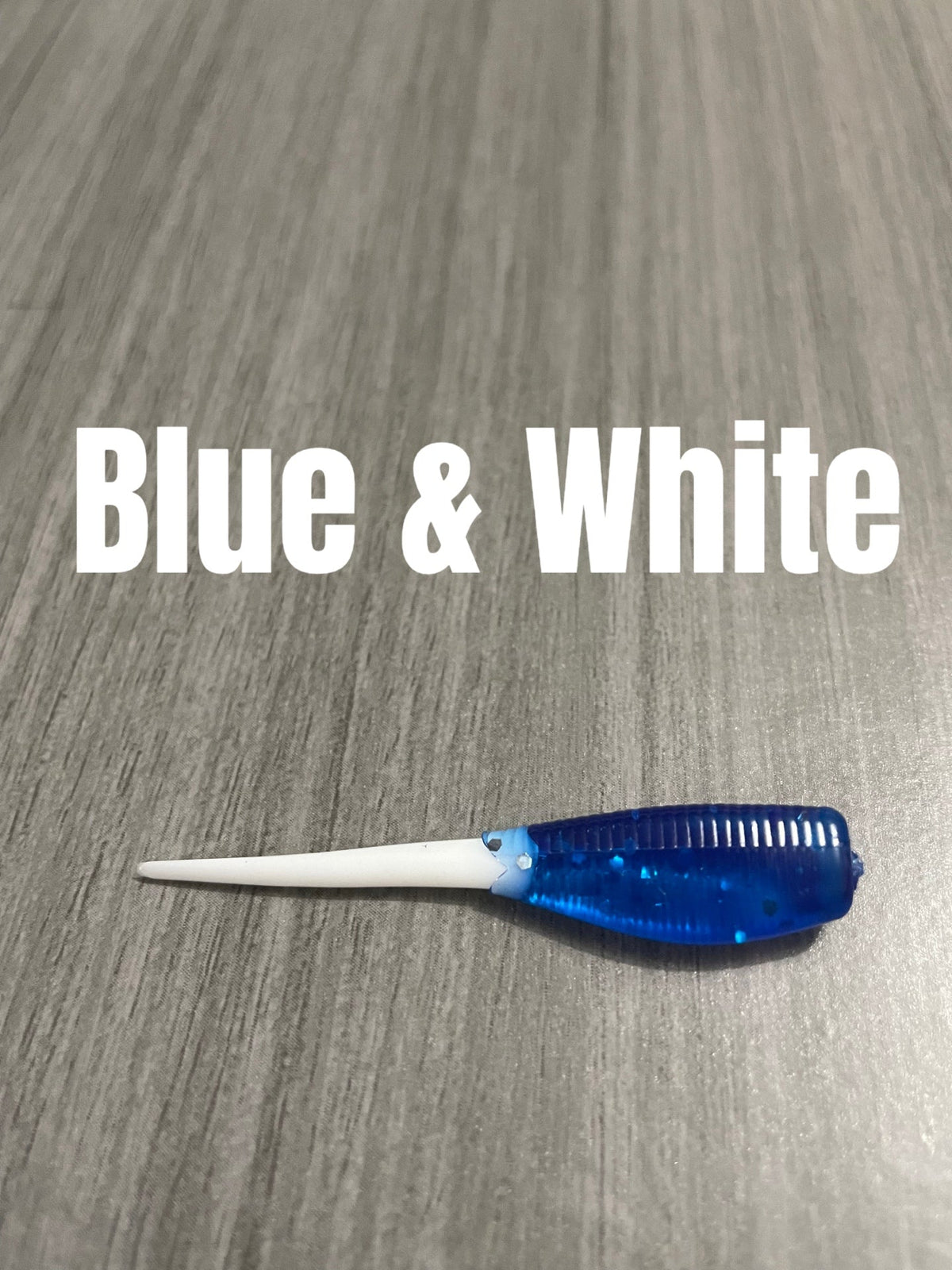 Blue and White Shad Body crappie bait with a translucent blue glittered ribbed body and slim pointed white tail.