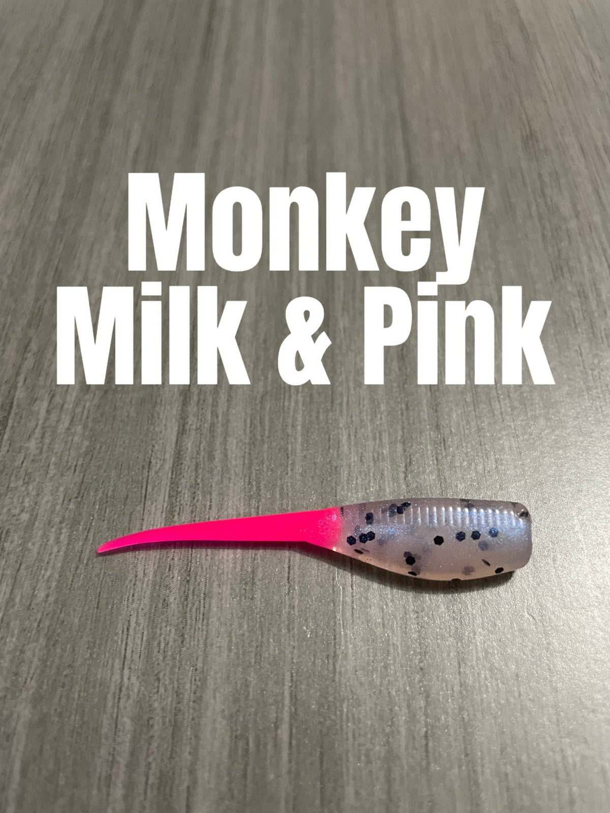 Shad Body crappie bait in Monkey Milk & Pink with a pearly translucent speckled body and bright pink tail.