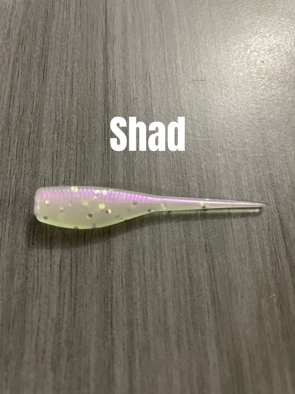 Shad Body crappie bait in Shad with pale translucent body, pink-purple back tint, and holographic flakes.
