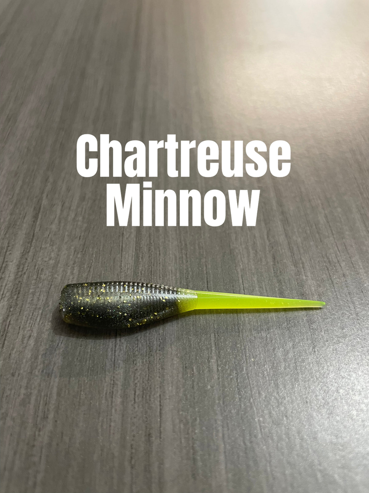 Chartreuse Minnow Shad Body crappie bait with a dark smoke-green glittered ribbed body and chartreuse tail.